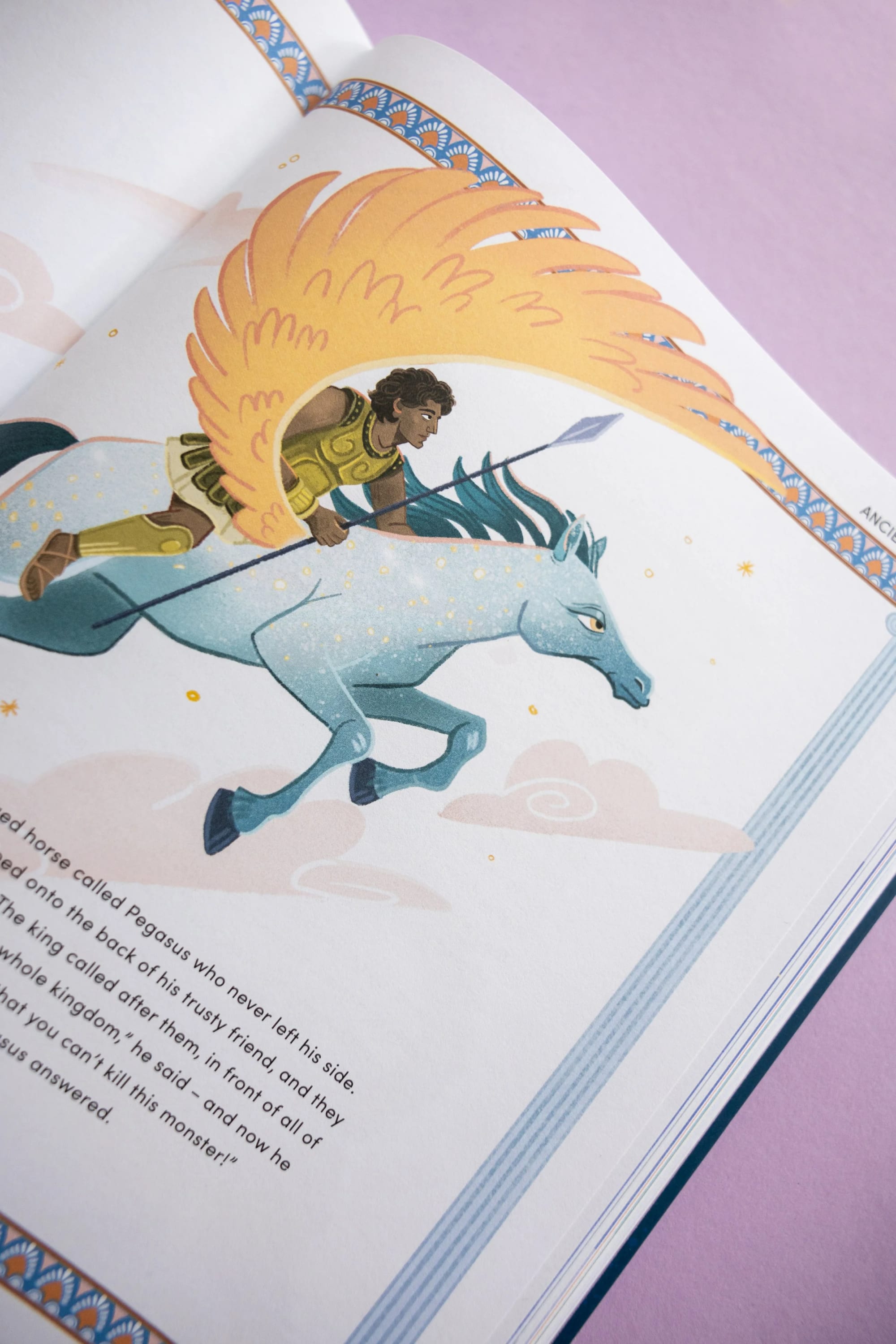 An illustration of a warrior riding a light blue Pegasus with a golden feathered wing, set against a pink background.
