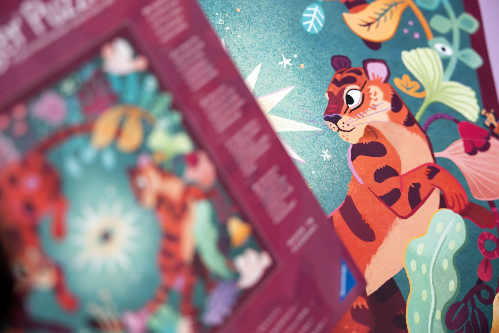 Colorful printed illustration of a tiger with a whimsical design, surrounded by leaves and nature elements.