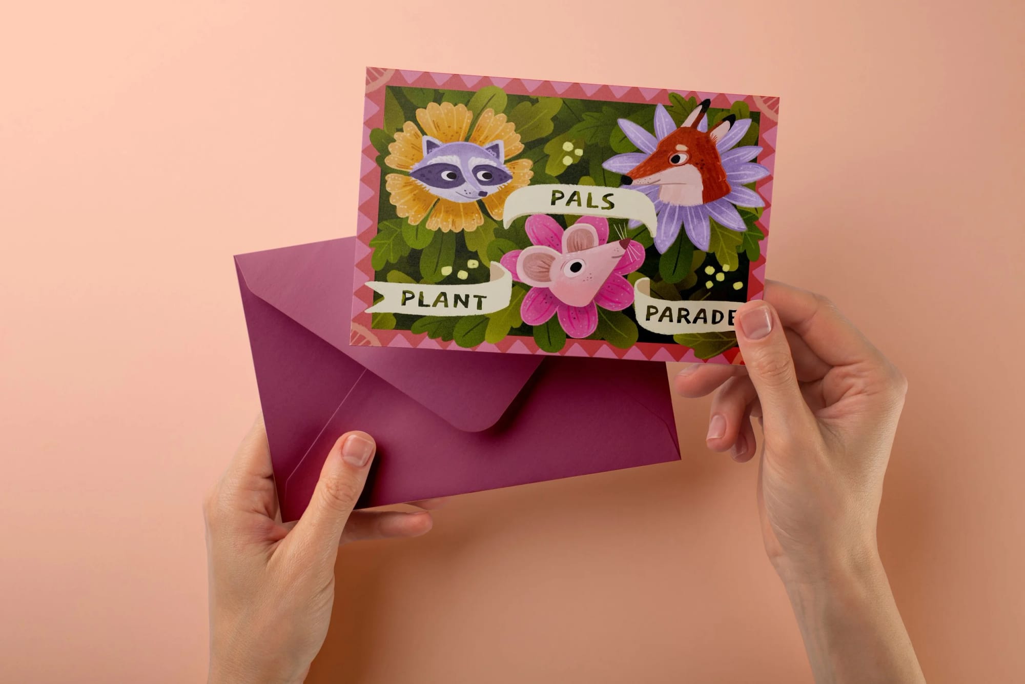 A person holding a pink envelope and a colorful card with cartoon animals and the words 'Plant Pals Parade' on it, with a light pink background.
