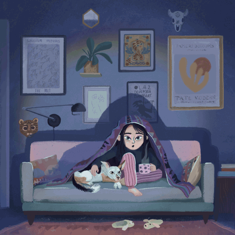 A girl sitting on a couch with a white cat, holding a gaming controller, in a dimly lit room decorated with wall art and plants.