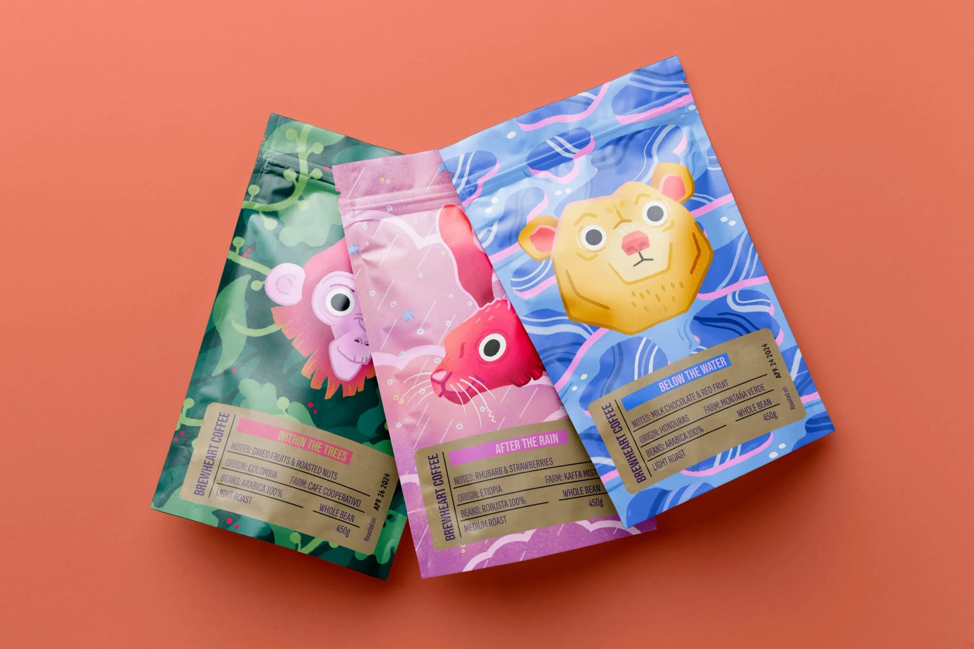 Three colorful coffee bags with animal illustrations and labels, placed on a pink background.