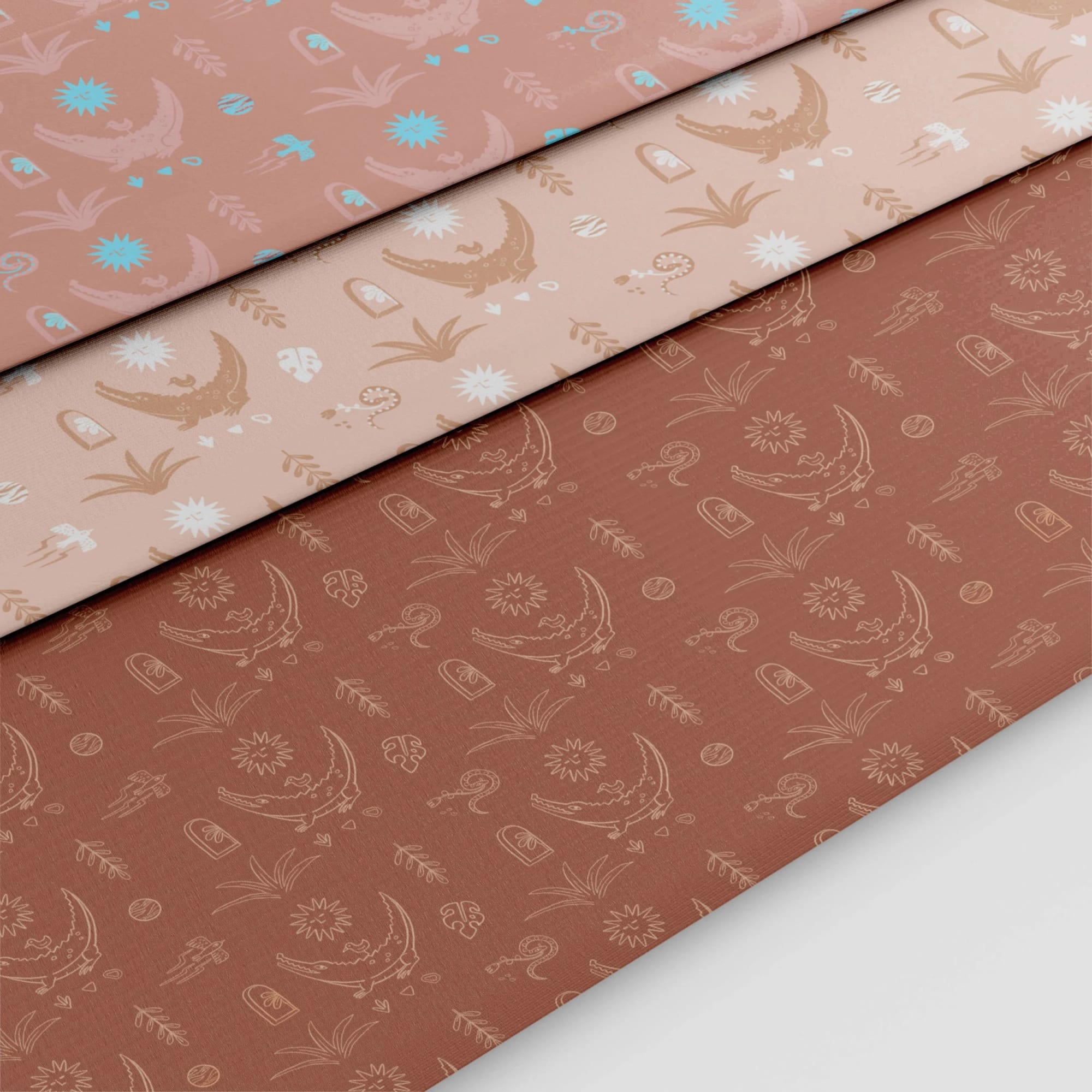 Three sheets of decorative paper with Halloween-themed patterns, including moons, bats, clouds, and spooky eyes, in pastel pink, light beige, and rust colors.