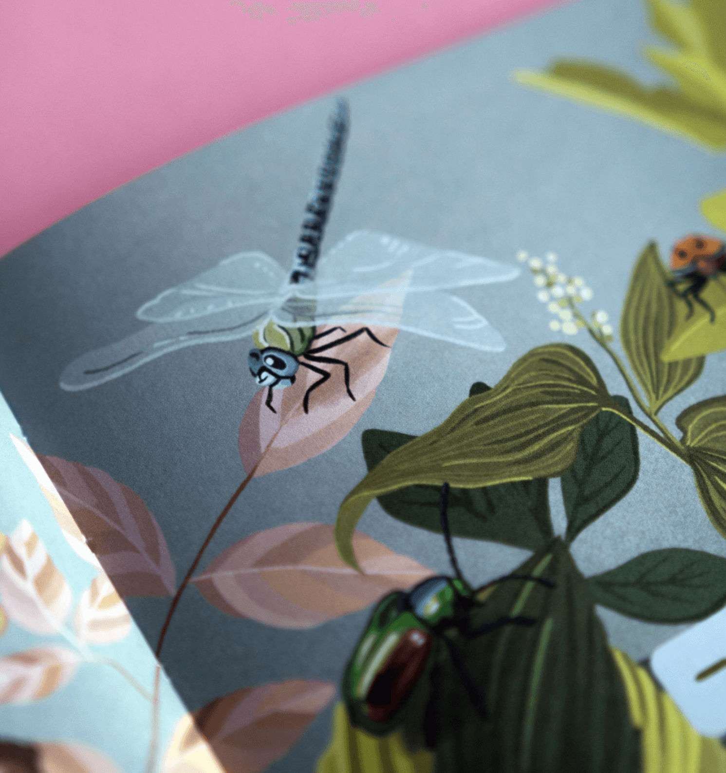 Illustration of various insects, including a dragonfly, beetle, and ladybug, among green foliage and branches.
