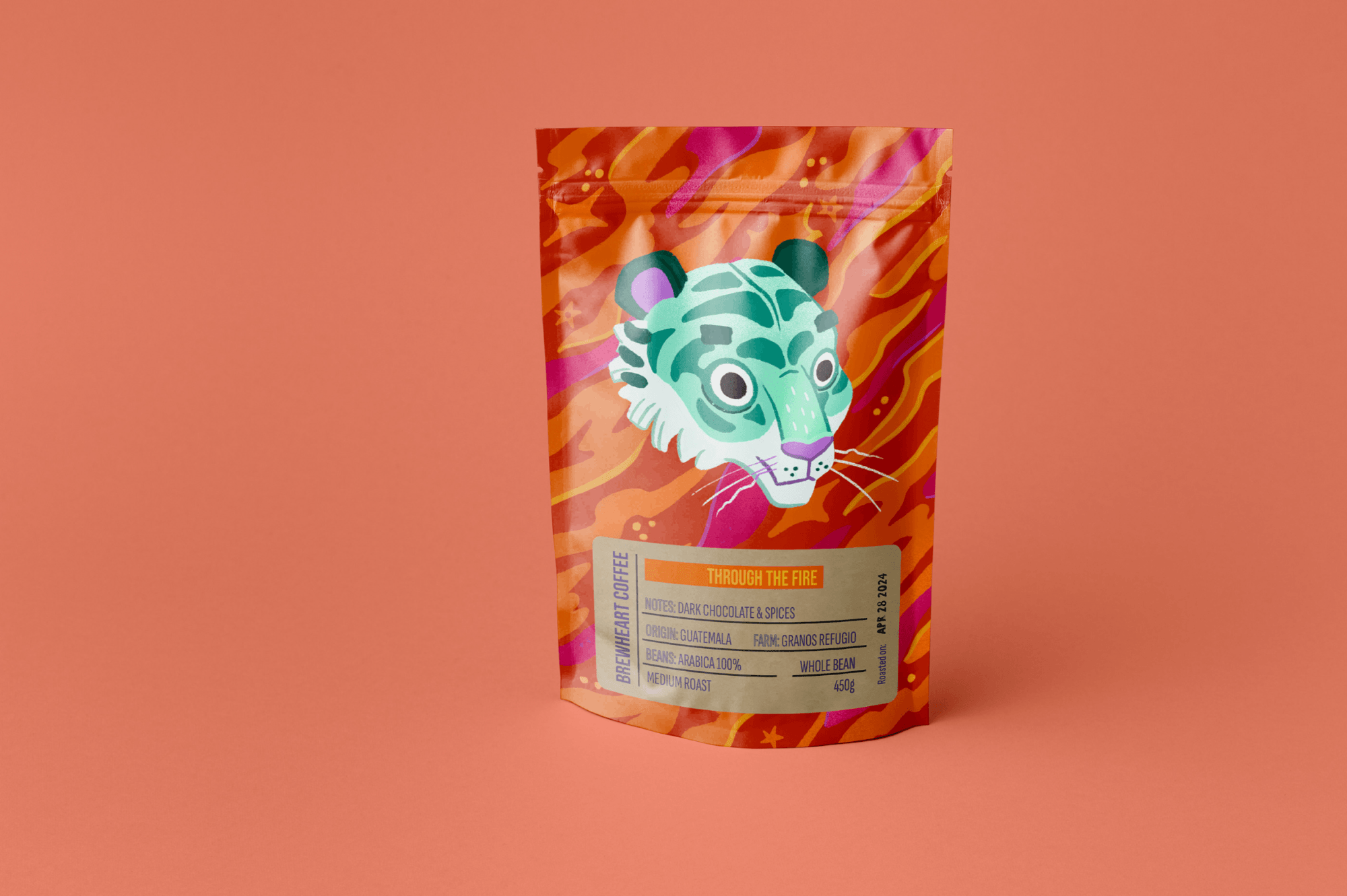 A colorful coffee bag with an illustrated tiger face on it, featuring teal and purple hues and a vibrant orange, pink, and purple background pattern.