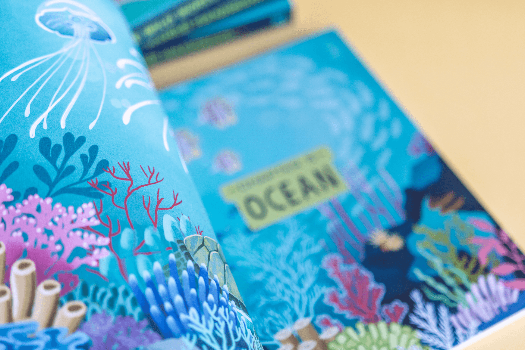 A colorful children's book about the ocean featuring illustrations of coral, fish, and underwater scenes.