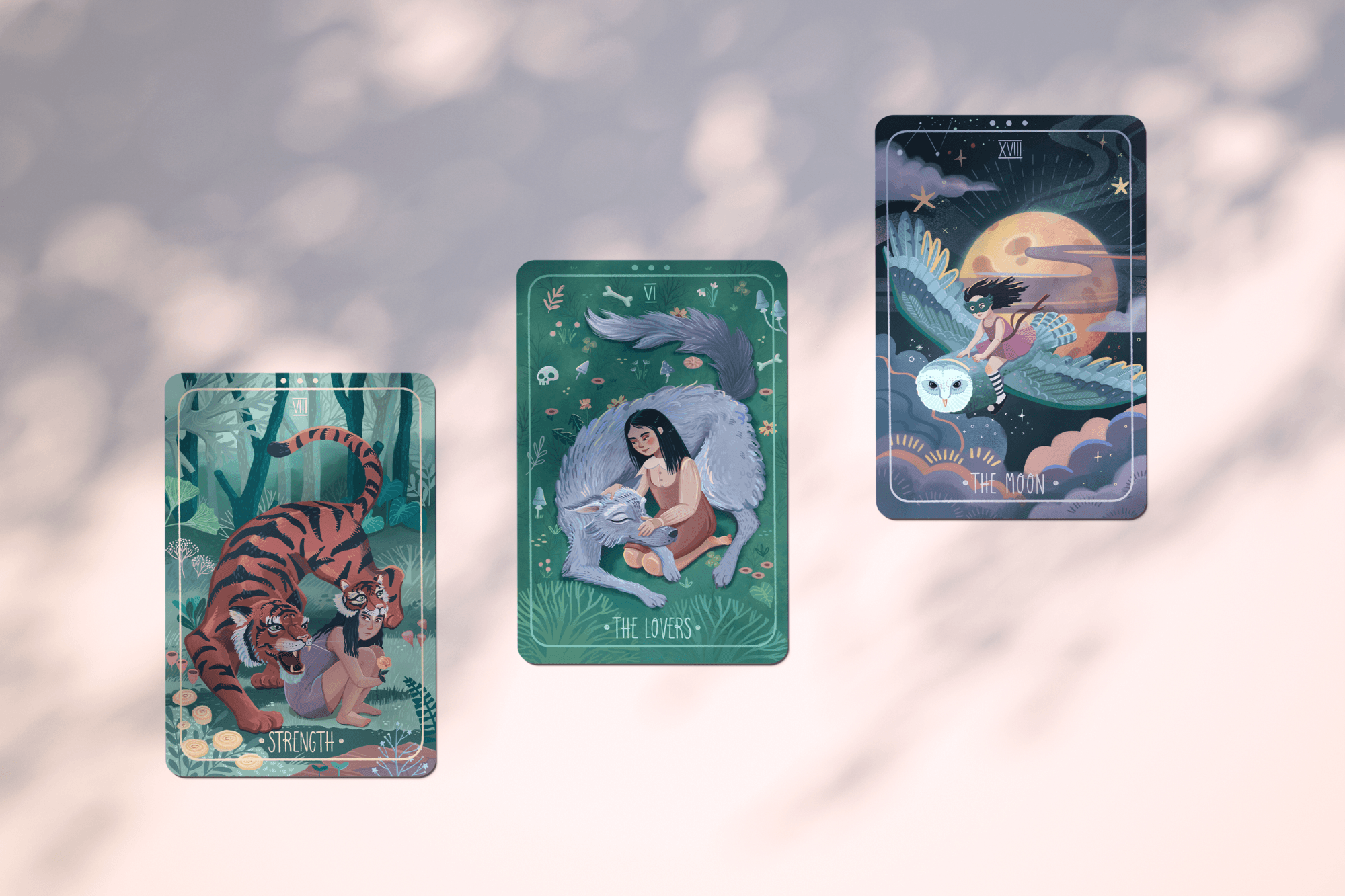 Three illustrated tarot cards floating against a cloudy sky, labeled Strength, The Lovers, and The Moon, each featuring a girl with animals.